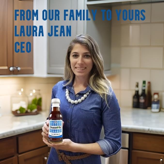 CEO Laura Jean in a kitchen holding a bottle of Southern Sweet Tea Co. real brewed Unsweetened Black Iced Tea.